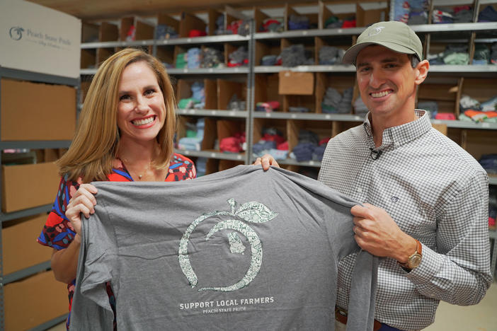 Derek and Kari Chitwood of Peach State Pride show off one of their shirts