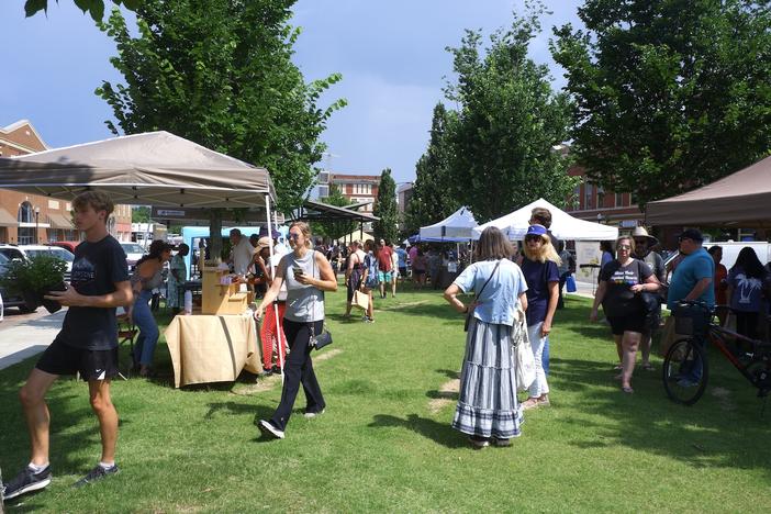 Locals buy goods and produce at the first Poplar Street Farmers Market on Wednesday, June 7, 2023. Eliza Moore / GPB News