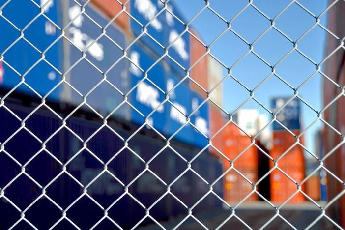 A rail yard behind a chain link fence