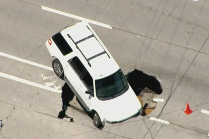 car in sinkhole
