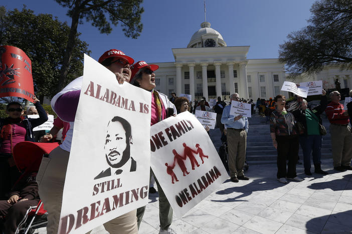 Demonstrators Gwendolyn Perrette, left, of Tuscaloosa, Ala., and Miriam Billanuava, of Birmingham, Ala., chant with others outside the Capitol in Montgomery, Ala., March 8, 2013.