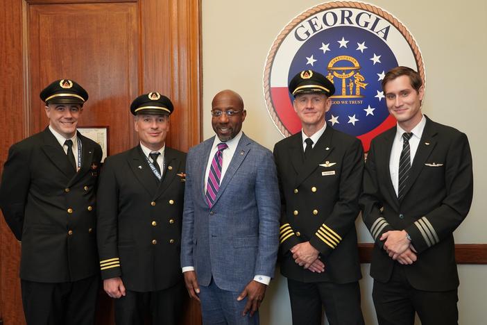 Sen. Reverend Raphael Warnock and a group of pilots.