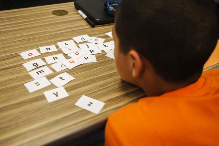 A student rests his chin on his desk during a summer reading class in Bibb County.