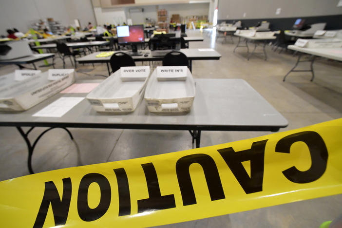 In this Tuesday, Nov. 24, 2020, file, photo, Cobb County Election officials prepare for a recount of ballots in Marietta, Ga. The Georgia State Election Board is asking a judge to order Texas-based True the Vote group, a conservative voting organization, to produce information to help investigate its claims of ballot trafficking in the state.