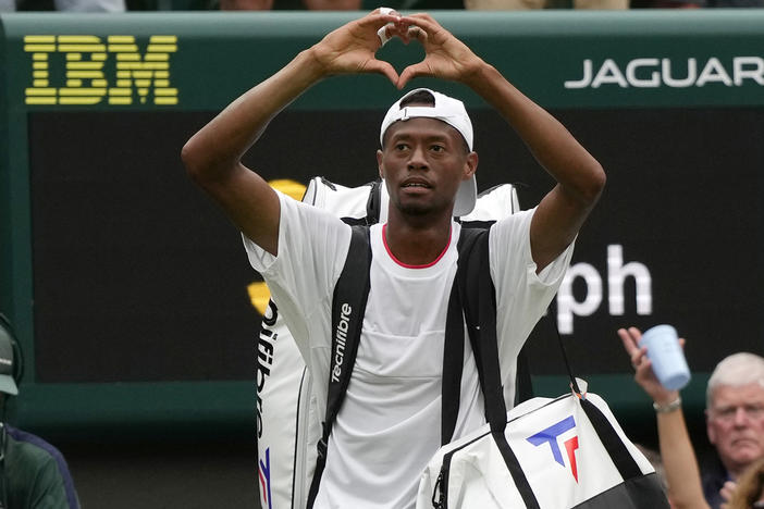 Christopher Eubanks of the US gestures to the crowd after losing to Russia's Daniil Medvedev in their men's singles match on day ten of the Wimbledon tennis championships in London, Wednesday, July 12, 2023. 