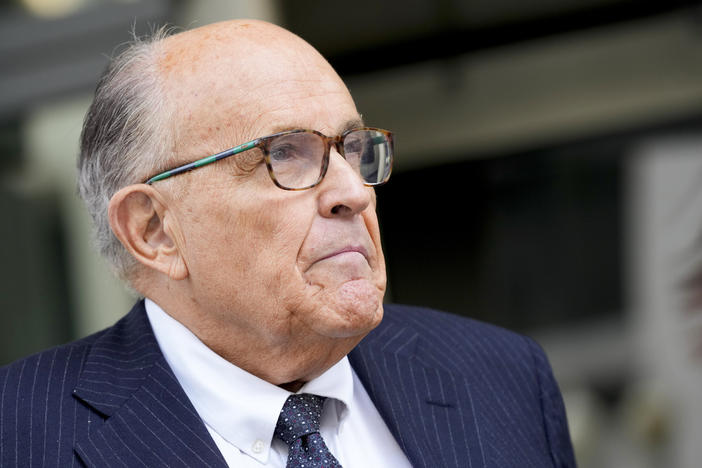 Rudy Giuliani speaks with reporters as he departs the federal courthouse, May 19, 2023, in Washington. Giuliani is not disputing that he publicly made statements about two Georgia election workers that were defamatory and false, but he contends they were constitutionally protected statements, according to a statement filed in court.