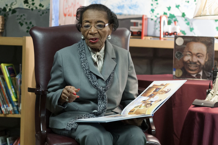 Dr. Christine King Farris reading to children at Hope Hill Elementary School.