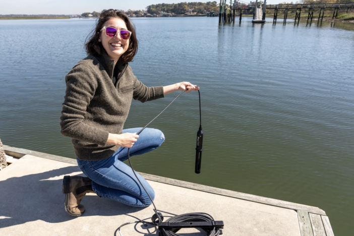 Mallory Mintz collecting water samples off the dock at Skidaway.