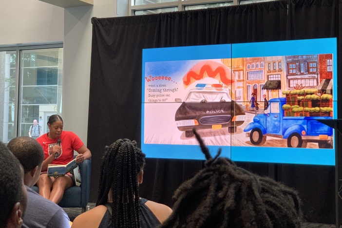 Former Atlanta Dream player Kia Vaughn reads Little Blue Truck Leads the Way written by Alice Schertle and illustrated by Jill McElmurry during a Mayor’s Summer Reading Club event at Georgia Public Broadcasting. Credit: Devon Zwald