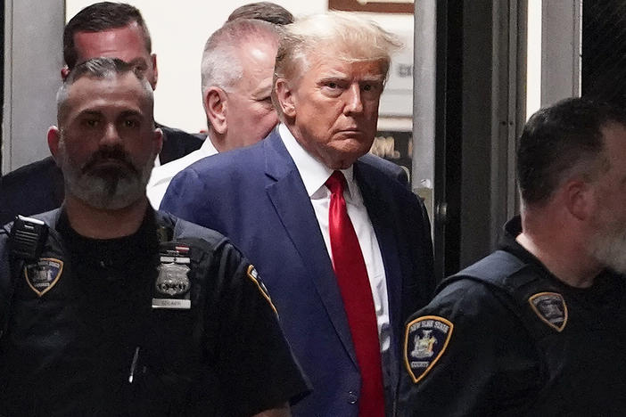 Former President Donald Trump is escorted to a courtroom, April 4, 2023, in New York. Trump’s bond has been set at $200,000 in the Georgia case accusing the former president of scheming to overturn his 2020 election loss. The bond agreement was outlined in a court filing signed by Fulton County District Attorney Fani Willis and Trump’s defense attorneys. 