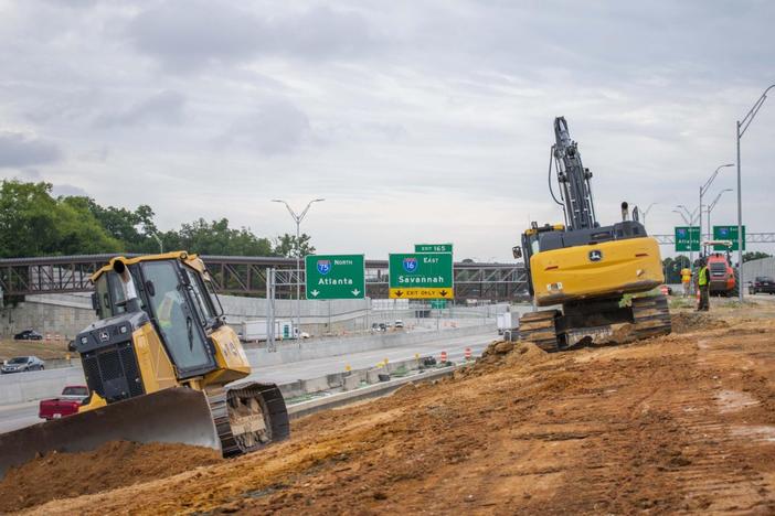 Two+bulldozers+operating+in+front+of+a+major+interstate+expansion+project Laura Corley | The Macon Newsroom Bulldozers plow through dirt between Interstate 75 north and the new on-ramp at Hardeman Avenue that splits for motorists to enter I-75 north or I-16 east. The construction work is part of the interchange expansion project that began six years ago and has no estimated date for completion.