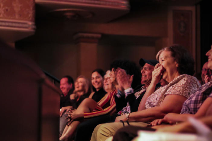 Audience members laughing at the Moth Mainstage