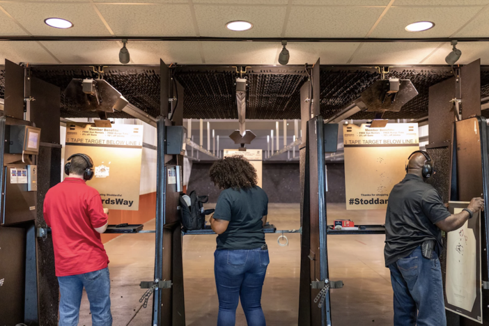 In this 2019 photo, NAAGA members Michael Doyle (left), Casandra Light and Colin Mapp prepare to shoot and review their targets in a gun range in Atlanta. 