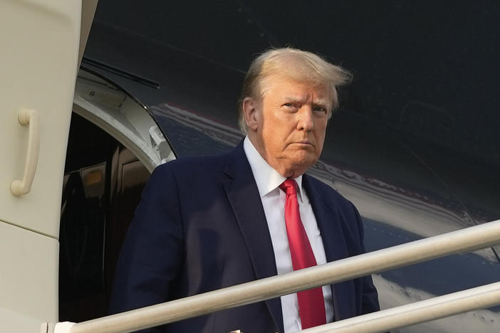 Former President Donald Trump steps off his plane as he arrives at Hartsfield-Jackson Atlanta International Airport, Thursday, Aug. 24, 2023, in Atlanta. 