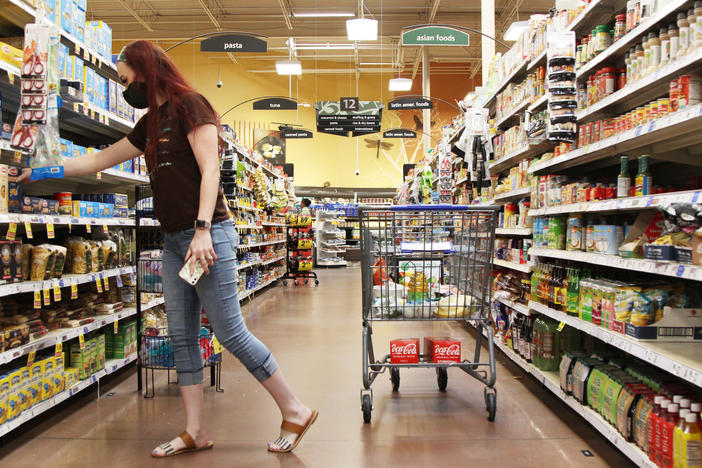 Julia Adele Callahan reaches for a box of pasta at a grocery store in Macon, Georgia, on August 15, 2022. Callahan and her two kids get WIC benefits every month that help pay for essential foods, like baby formula, whole grains, dairy and protein.