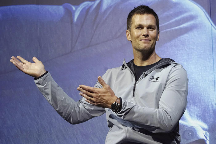 New England Patriots quarterback Tom Brady gestures during a promotional event, June 22, 2017, in Tokyo. Brady is putting on a Delta Air Lines uniform, at least figuratively. Delta said Wednesday, Sept. 6, 2023, that it has agreed to bring the former star quarterback on board as a long-term strategic adviser. 