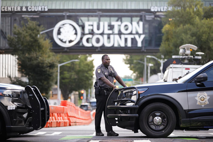 A sheriff's deputy stands guard near the Fulton County Courthouse, Monday, Aug. 14, 2023, in Atlanta.