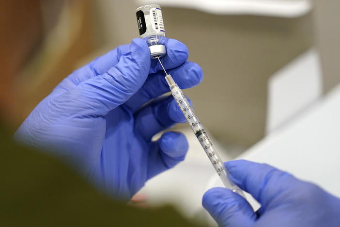 A healthcare worker fills a syringe with the Pfizer COVID-19 vaccine at Jackson Memorial Hospital Tuesday, Oct. 5, 2021, in Miami. A recent recommendation by the Food and Drug Administration and Centers for Disease Control and Prevention is advising people who are 65 and older, and workers whose jobs put them at high risk of exposure â€“ including those in healthcare â€“ to receive a booster shot six months after their second shot.