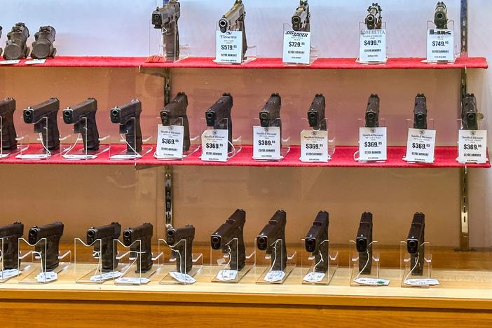 A large selection of used handguns that were traded in from law enforcement officials on display at Clyde Armory in Warner Robins. Credit: Justin Taylor/The Current