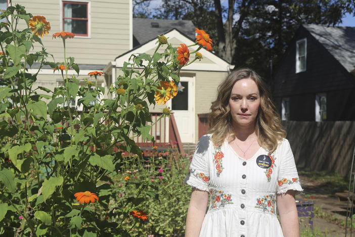 Actor Bethany Anne Lind stands in her backyard garden in Atlanta, wearing a pin in support of the SAG-AFTRA union on Oct. 18, 2023. Lind has been a vocal proponent of the strike, which has had an especially large effect on Atlanta, one of the nation's filming hubs.