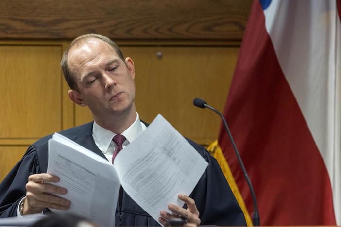 Fulton County Superior Judge Scott McAfee looks through paperwork during a jury questionnaire hearing in his courtroom at the Fulton County Courthouse on Monday, Oct. 16, 2023, in Atlanta. 