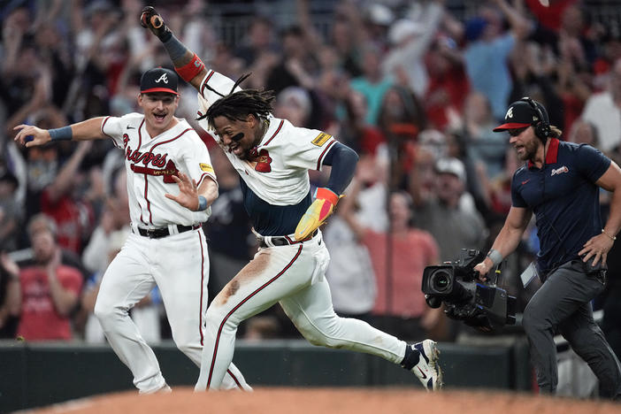 Atlanta Braves' Ronald Acuña Jr. celebrates after scoring the winning run on an Ozzie Albies base hit during the 10th inning of a baseball game against the Chicago Cubs, Wednesday, Sept. 27, 2023, in Atlanta. Acuña stole two bases in the game to become the first player in the majors to steal 70 bases and hit 40 home runs in a season.