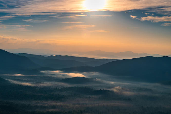 A picture of the sun rising over the Blue Ridge mountains.