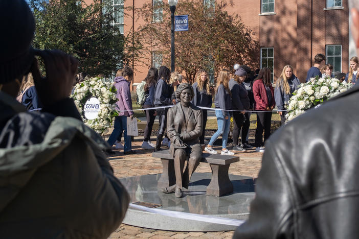 Visitors surround a bronze statue of former First Lady Rosalynn Carter at Georgia Southwestern State University on Nov. 27.