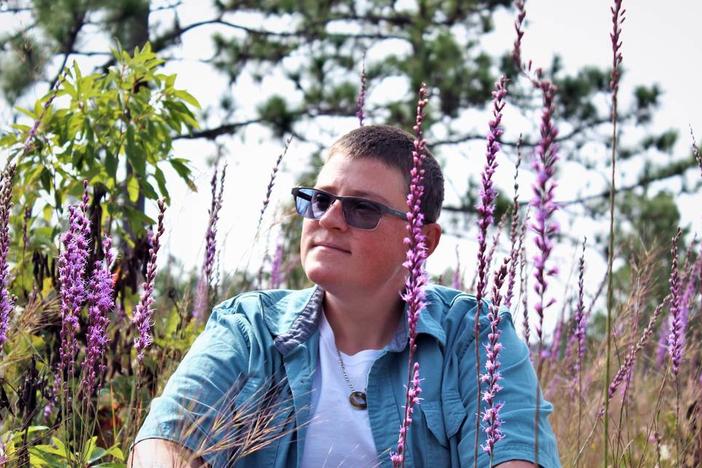 Ashley Desensi sits among a superbloom of (liatris) blazingstar at the Canoochee Sandhills Photo courtesy of Ashley Desensi  