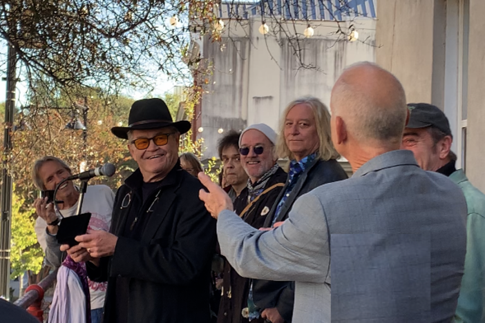 Singer Mickey Dolenz of the Monkees accepts a ceremonial key to the city of Athens, Ga. from Mayor Kelly Girtz (right) on Nov. 3, 2023 as R.E.M. members Michael Stipe, Peter Buck, Bill Berry and fellow musicians watch. 