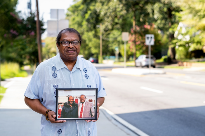 Reverend Tim McDonald holding a photo of Emanuel Biggs, who was killed on Atlanta's Moreland Avenue in October 2022.