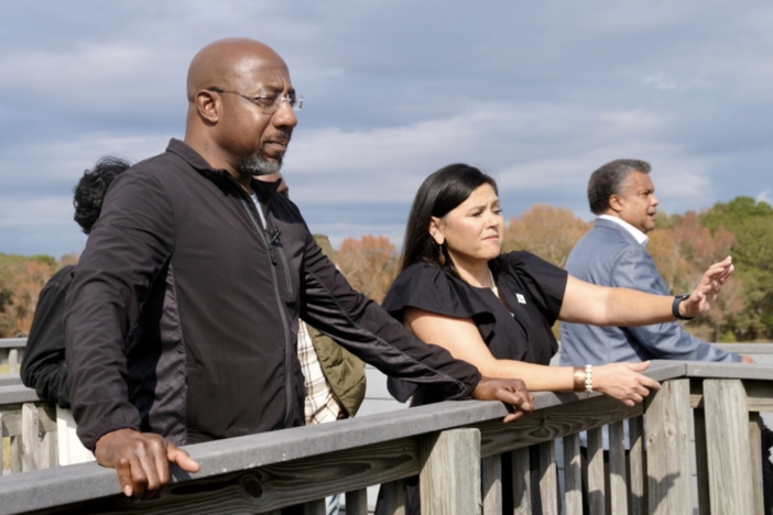 Tracie Revis, a citizen of the Muscogee Creek Nation, admires the view from the Great Temple Mound complex with Senator Warnock during his tour of Ocmulgee National Historic Park.