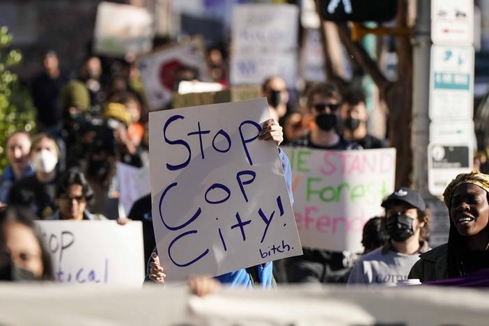 Demonstrators march to the courthouse supporting 61 defendants that are being arraigned on RICO charges related to vandalism at the site of the new Public Safety Training Center, outside the a Fulton County courthouse, Monday, Nov. 6, 2023, in Atlanta. 