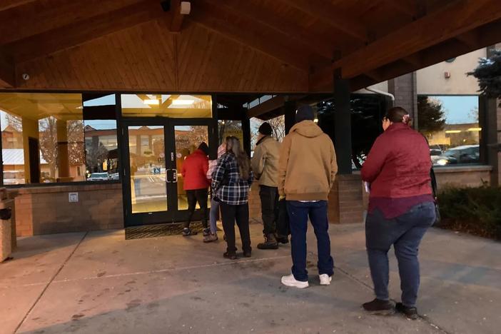 People line up outside a public assistance office in Missoula, Montana, before its doors open at 8 a.m., Oct. 27, 2023, to try to regain Medicaid coverage after being dropped from the government insurance program for people with low incomes and disabilities. Each said they had experienced long waits on the state's phone helpline.