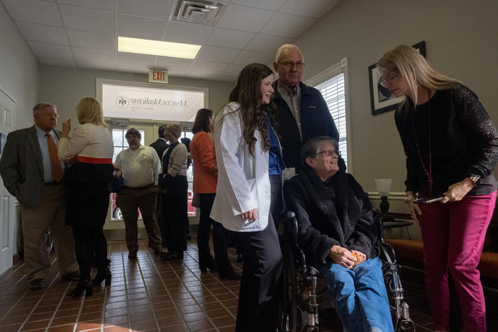 Medical student Emily Hartley from Reynolds talks to her neighbors at the ribbon cutting for the Mercer Medicine clinic in Taylor County.