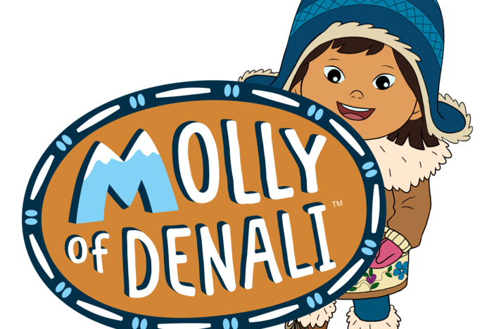 Molly of Denali is dressed in winter gear and holds the logo