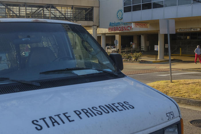 A Georgia Department of Corrections van parked outside Atrium Health at Navicent's emergency room in Macon on December 20. Two inmates from GDC's Central State Prison were declared dead from stab wounds within 48 hours of each other and after being treated at the hospital earlier in the month. 