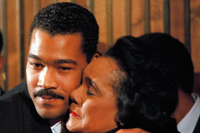 Dexter Scott King, youngest son of Dr. Martin Luther King, Jr., gets a hug from his mother, Coretta Scott King, at a news conference, Jan. 14, 1989, in Atlanta where it was announced that he would replace her as president of the King Center as of April 4.