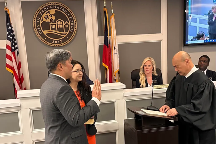 Mayor John Park being sworn in with his wife, Morgan Harris, at his swearing in on Jan. 8, 2024.