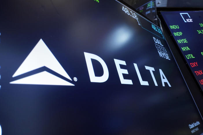 The logo for Delta Air Lines appears on a screen above a trading post, on the floor of the New York Stock Exchange, Thursday, July 13, 2023. Delta Air Lines earned $2 billion in the fourth quarter, posted record full-year revenue, and says it's buying more planes to boost its international flying.