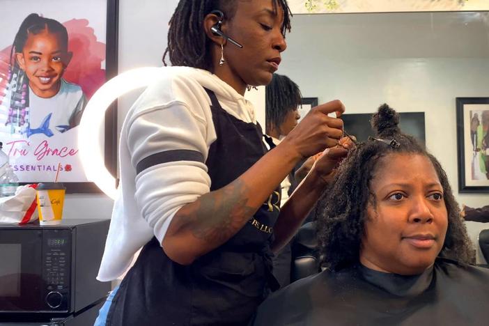 Taniesa Taylor, the owner of Locs, Twists, Braids and Crochets in Columbus, Georgia styles Shawnitra Williams’ hair recently. 01/11/2024 Mike Haskey mhaskey@ledger-enquirer.com  