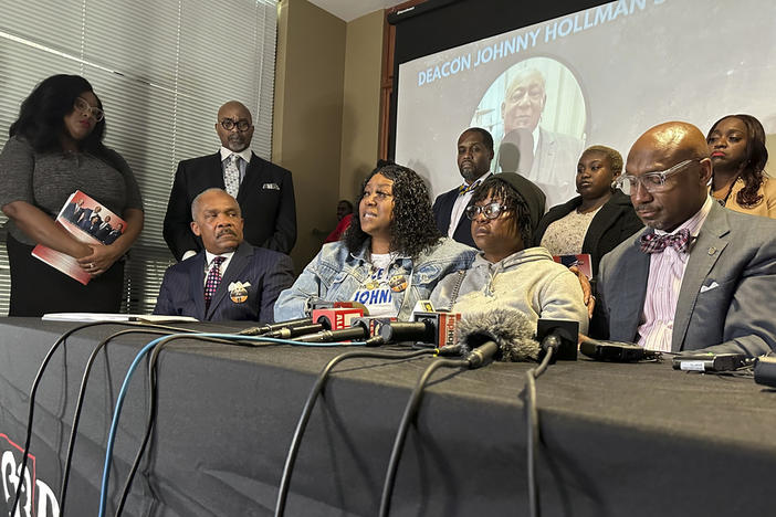Arnitra Hollman, seated second from left, speaks during a news conference announcing a lawsuit over the death of her father, Johnny Hollman in Decatur, Ga., Thursday, Jan. 18, 2024. Hollman died after struggling with an Atlanta police officer on Aug. 10, 2023, following a minor car crash. Seated from left to right, attorney Harold Spence, Arnitra Hollman, her sister Myteka Burdett and attorney Mawuli Davis. 