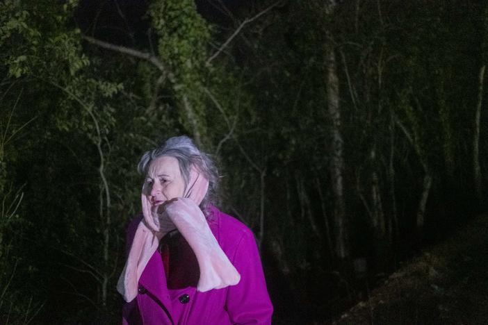 June O'neal yells an offer of cold weather shelter toward a homeless encampment by the Ocmulgee River in Macon.