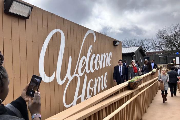 A “Welcome Home” mural greets tenants and visitors to Atlanta’s first rapid housing community for those experiencing homelessness. The project was built on a former city parking lot and includes 40 micro-units made from repurposed shipping containers. (Dyana Bagby)