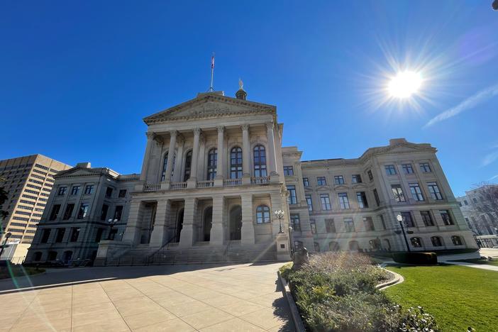 front lawn view of Georgia state capitol building with sun shining