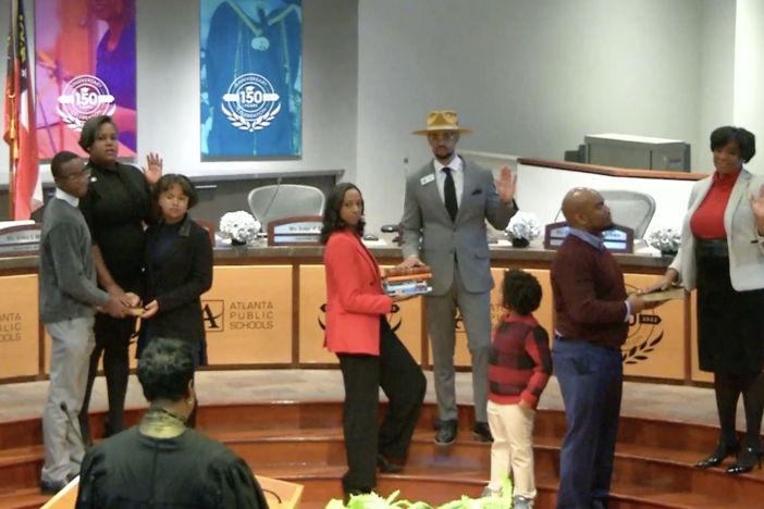 Alfred Brooks (in hat), an economics teacher at Charles Drew High School in Clayton County with 13 years of teaching experience, is sworn in as the District 7 At-Large member on Jan. 8, 2024. 
