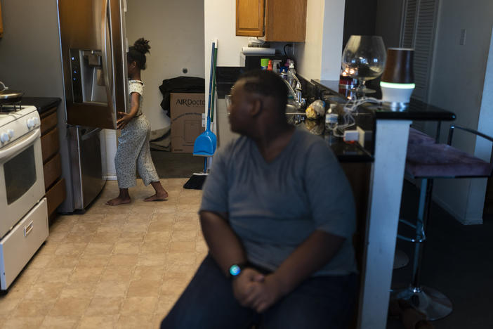 John Simon, a teenager who had a bariatric surgery in 2022, watches as his sister, Haley, opens a refrigerator for food in their apartment in Los Angeles, Monday, March 13, 2023.