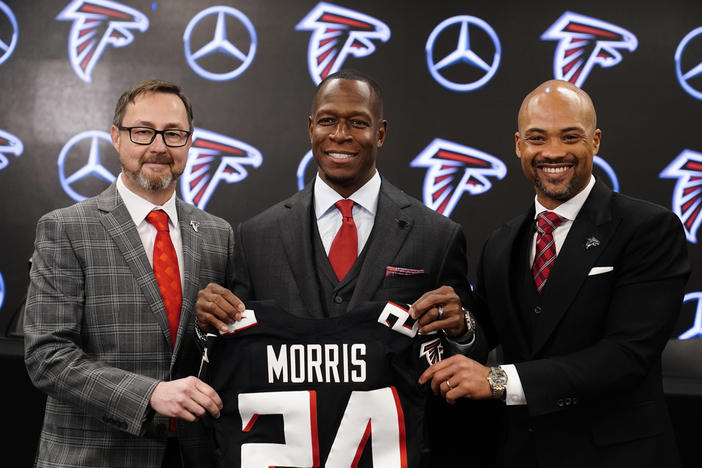 Atlanta Falcons president, Greg Beadles, left, head coach Raheem Morris, center, and general manager Terry Fontenot, right, pose after an NFL football news conference, Monday, Feb. 5, 2024, in Atlanta.
