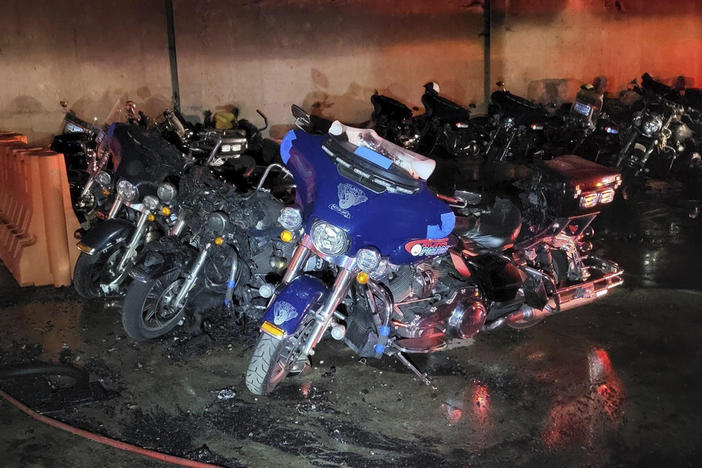 This photo provided by the Atlanta Police Department show torched police motorcycles after a July 1, 2023, attack at a police precinct in southeast Atlanta. Authorities on Thursday, Feb. 8, 2024, announced they have arrested John Robert Mazurek, 30, in connection with the attack and charged him with first-degree arson. 