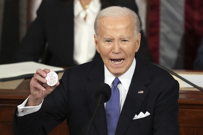 President Joe Biden holds up a Laken Riley Botton as he delivers the State of the Union address to a joint session of Congress at the U.S. Capitol, Thursday March 7, 2024, in Washington. 